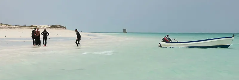 Briefing on the beach, boat on mooring